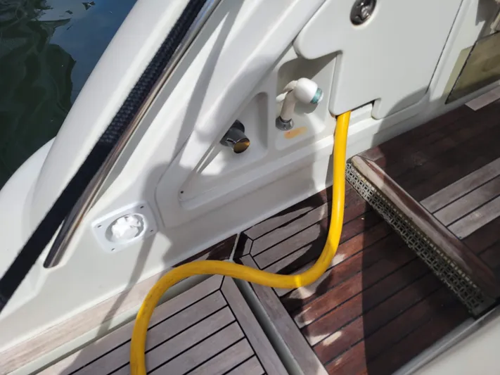 Fantasia 04 Yacht Photos Pics 2009 Azimut 43S yacht deck with yellow hose and wooden flooring.