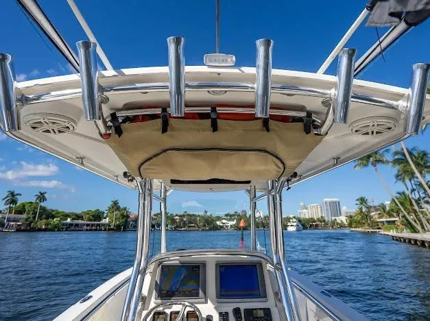  Yacht Photos Pics Edgewater 318CC boat console with rod holders, cruising on a sunny day, 2010 model.