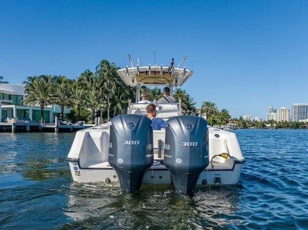  Yacht Photos Pics 2010 Edgewater 318CC boat with dual 300 horsepower engines on a sunny waterway.