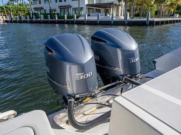  Yacht Photos Pics Twin Yamaha 300 engines on a 2010 Edgewater 318CC boat, docked by waterfront homes.