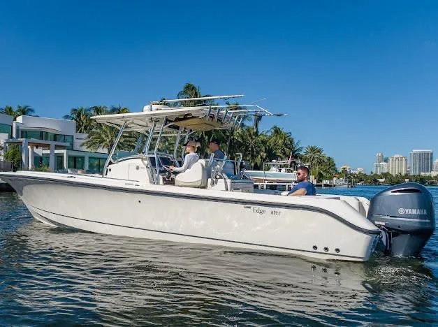  Yacht Photos Pics 2010 Edgewater 318CC boat cruising on a sunny day with passengers onboard.