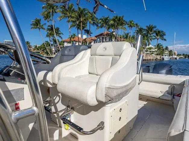  Yacht Photos Pics 2010 Edgewater 318CC boat interior with white seating, palm trees, and waterfront view.