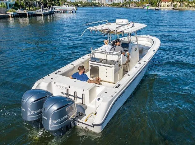  Yacht Photos Pics 2010 Edgewater 318CC boat with dual Yamaha engines cruising on a sunny waterway.