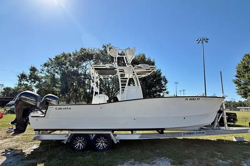  Yacht Photos Pics 2015 Calcutta 263 boat on trailer with dual Mercury engines, parked outdoors.