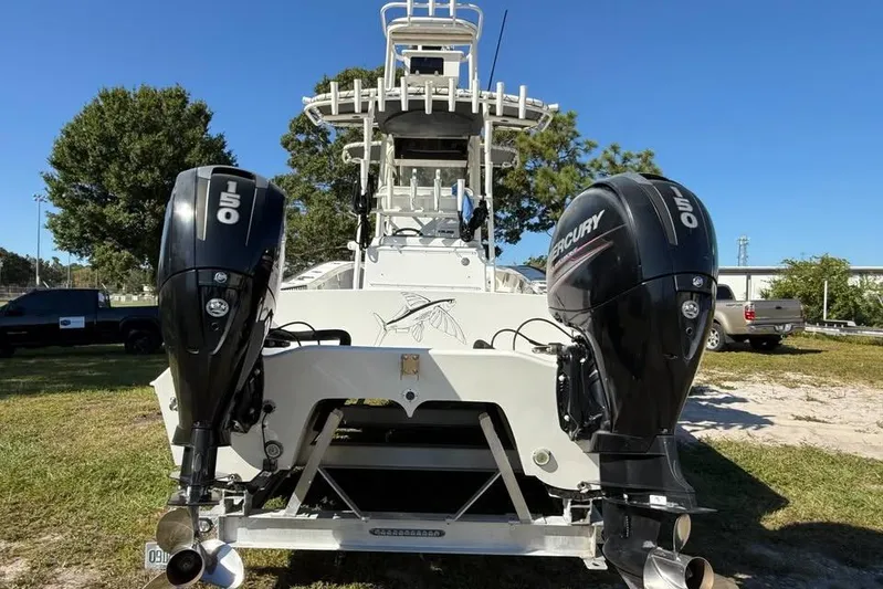  Yacht Photos Pics 2015 Calcutta 263 boat with dual Mercury 150 outboard engines, parked on grass.