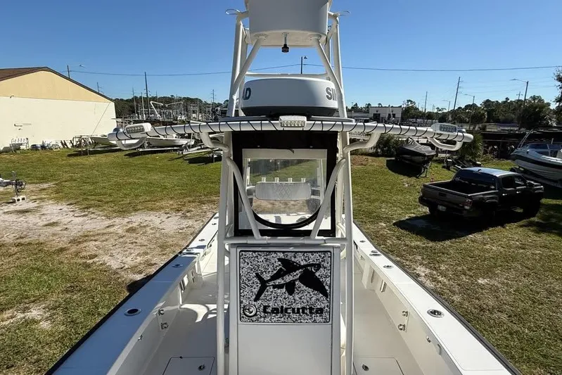  Yacht Photos Pics Calcutta 263 boat, 2015 model, parked outdoors on grass under clear blue sky.