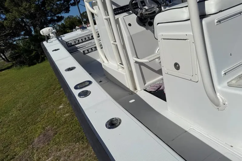  Yacht Photos Pics Calcutta 263 boat deck, 2015 model, featuring rod holders and storage compartments.