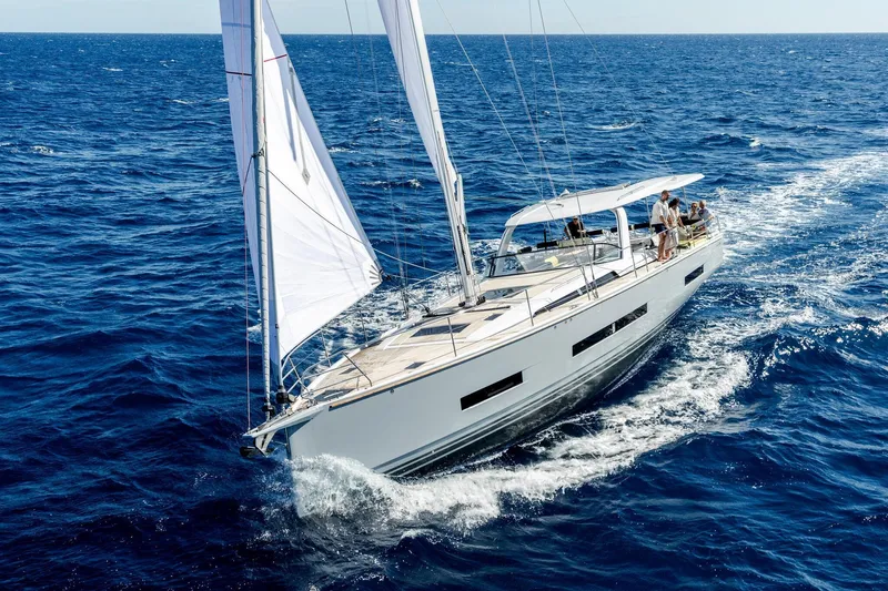  Yacht Photos Pics Sailing yacht Hanse 590, 2026 model, cruising on open sea with passengers onboard.