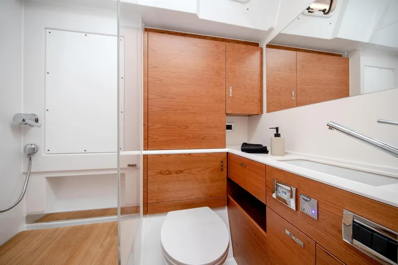  Yacht Photos Pics Modern bathroom interior on 2026 Hanse 590 yacht, featuring sleek wood cabinetry and contemporary fixtures.