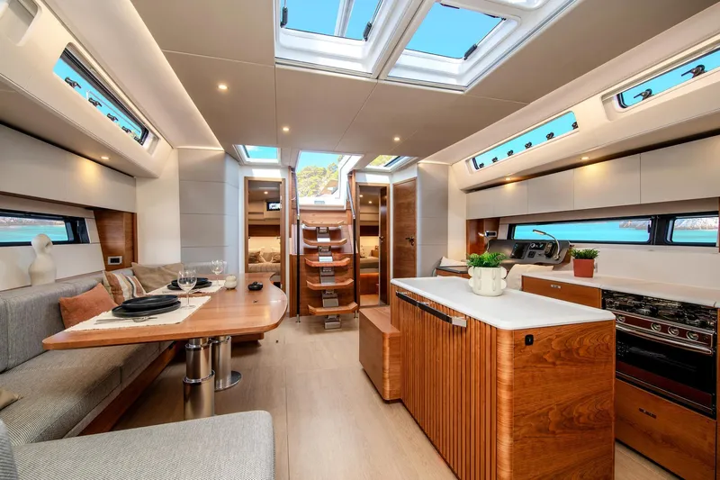 Yacht Photos Pics Luxurious interior of 2026 Hanse 590 yacht with modern kitchen and dining area.
