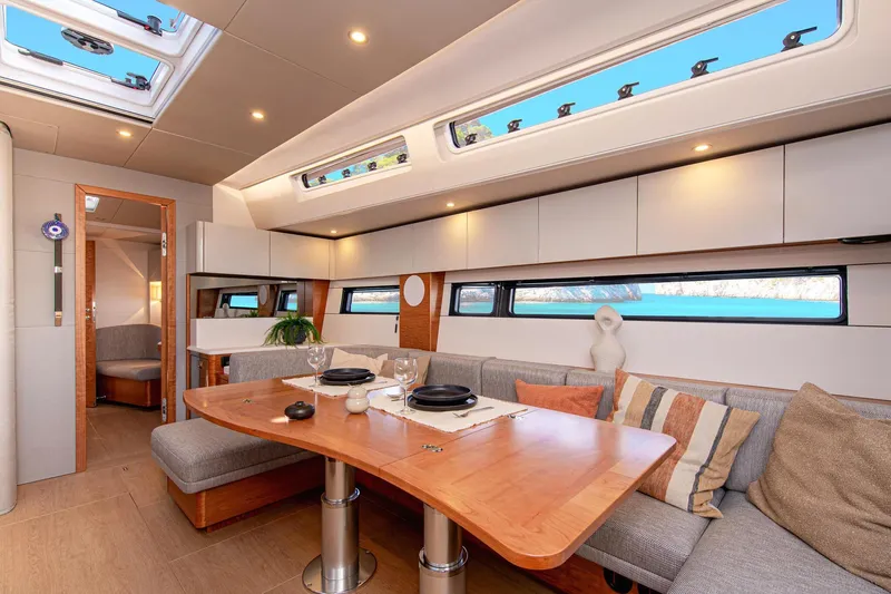  Yacht Photos Pics Luxurious interior of 2026 Hanse 590 yacht with elegant dining area and scenic windows.