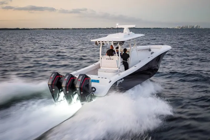  Yacht Photos Pics 2023 Yellowfin 34 boat speeding on open water at sunset.
