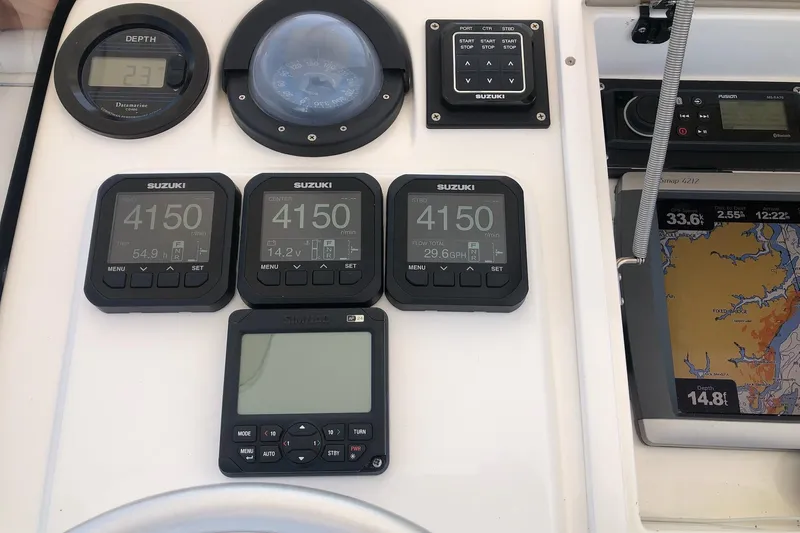 Mac & Seas Yacht Photos Pics Boat dashboard with Suzuki gauges and navigation system on a 2000 Intrepid 356 Cuddy.