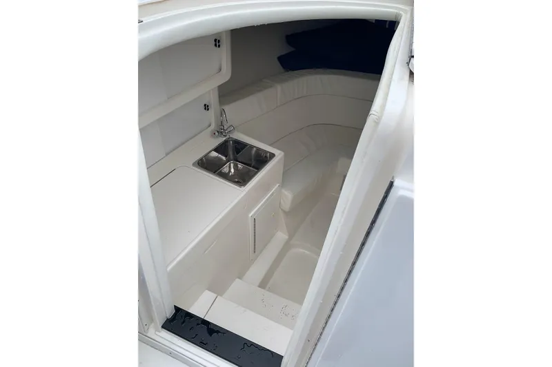 Mac & Seas Yacht Photos Pics 2000 Intrepid 356 Cuddy cabin interior with sink and seating area.