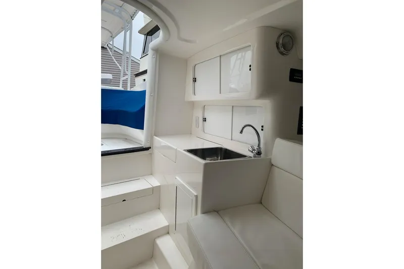 Mac & Seas Yacht Photos Pics Interior of 2000 Intrepid 356 Cuddy boat with sink and seating area.
