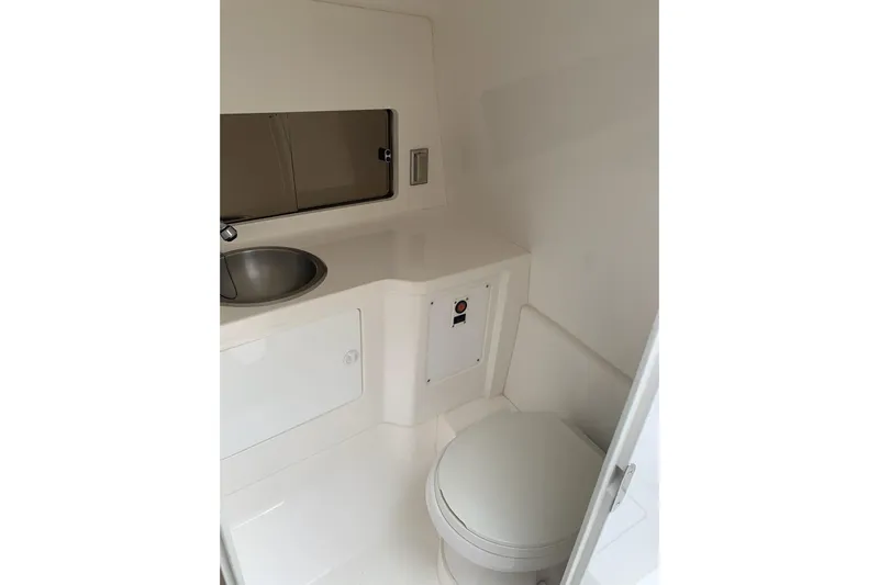 Mac & Seas Yacht Photos Pics Intrepid 356 Cuddy 2000 boat interior bathroom with sink and toilet.