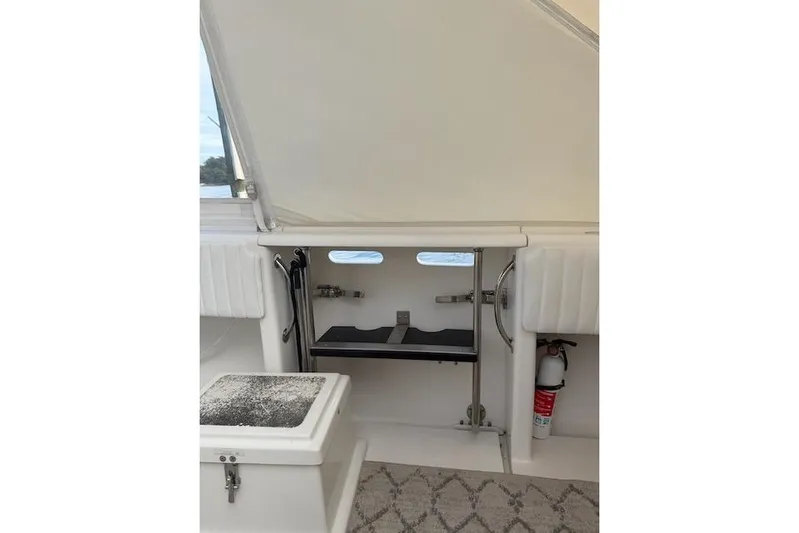 Mac & Seas Yacht Photos Pics 2000 Intrepid 356 Cuddy interior with storage and fire extinguisher.