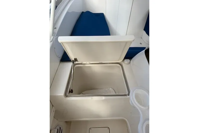 Mac & Seas Yacht Photos Pics Open storage compartment on 2000 Intrepid 356 Cuddy boat with blue seating.