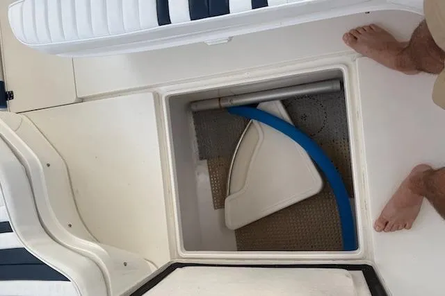 Mac & Seas Yacht Photos Pics Storage compartment on a 2000 Intrepid 356 Cuddy boat with visible equipment.