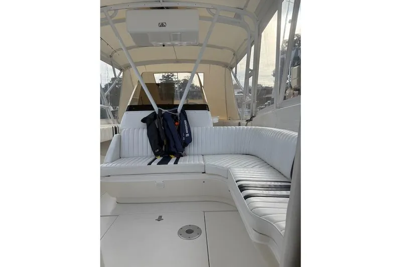 Mac & Seas Yacht Photos Pics Interior of a 2000 Intrepid 356 Cuddy boat with white seating and life jackets.