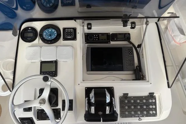 Mac & Seas Yacht Photos Pics Control panel of a 2000 Intrepid 356 Cuddy boat with navigation instruments.