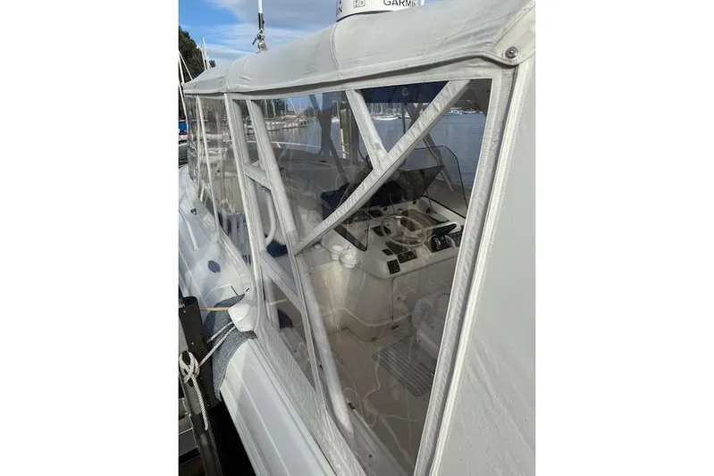 Mac & Seas Yacht Photos Pics 2000 Intrepid 356 Cuddy boat with enclosed cockpit, docked at marina.