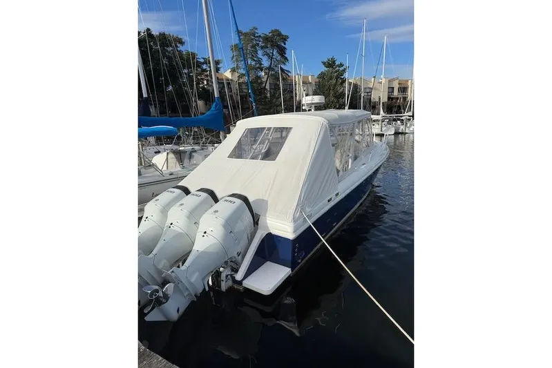 Mac & Seas Yacht Photos Pics 2000 Intrepid 356 Cuddy boat docked with triple outboard engines.