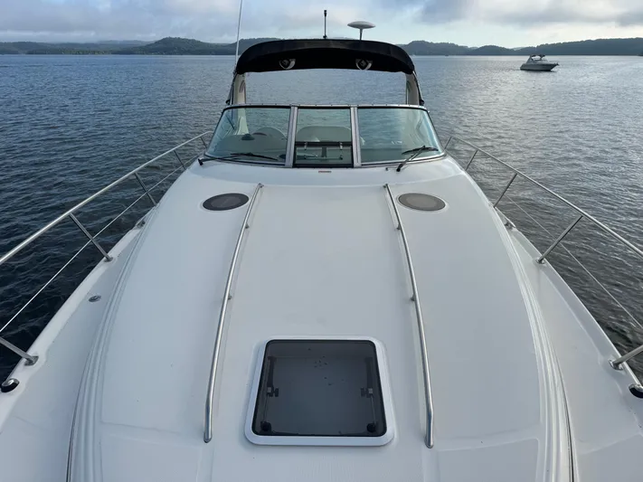  Yacht Photos Pics 2004 Sea Ray 360 Sundancer yacht on calm water, showcasing sleek deck design.