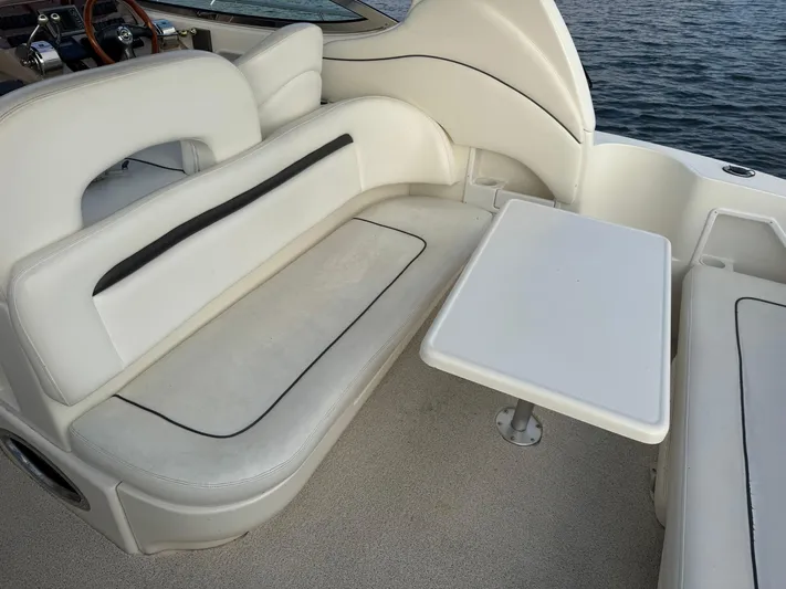 Yacht Photos Pics 2004 Sea Ray 360 Sundancer interior with white seating and table, overlooking water.