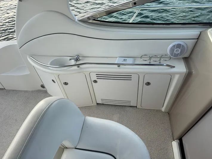  Yacht Photos Pics 2004 Sea Ray 360 Sundancer interior with sink, storage cabinets, and speaker by the water.