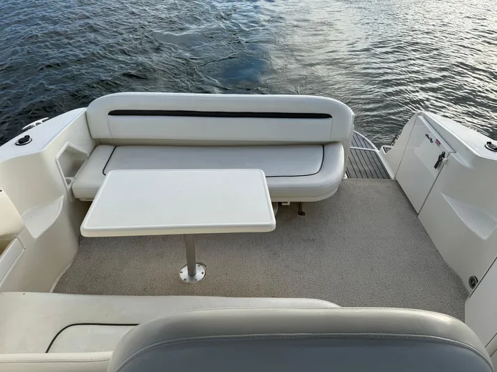  Yacht Photos Pics 2004 Sea Ray 360 Sundancer boat interior with seating and table, overlooking water.