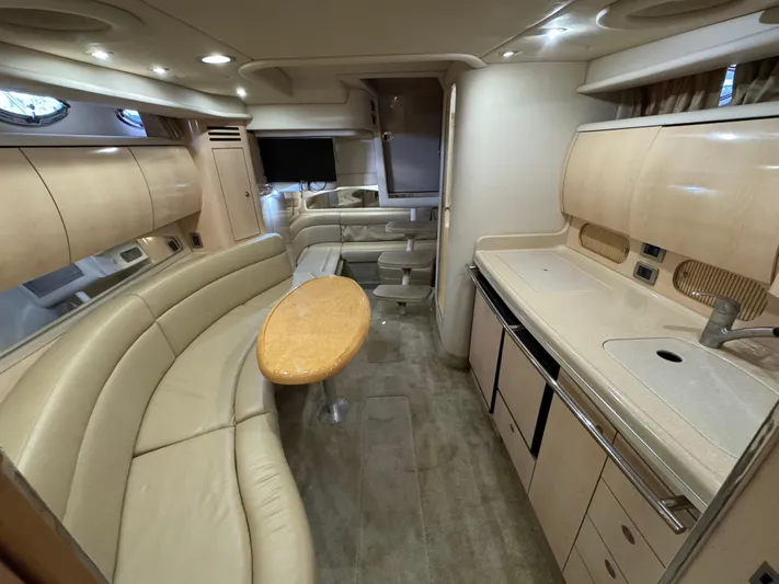  Yacht Photos Pics Luxurious interior of a 2004 Sea Ray 360 Sundancer yacht with elegant seating and kitchenette.