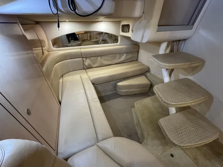  Yacht Photos Pics 2004 Sea Ray 360 Sundancer interior with beige leather seating and carpeted steps.