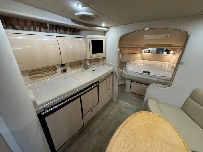  Yacht Photos Pics 2004 Sea Ray 360 Sundancer interior with kitchenette, seating, and sleeping area.