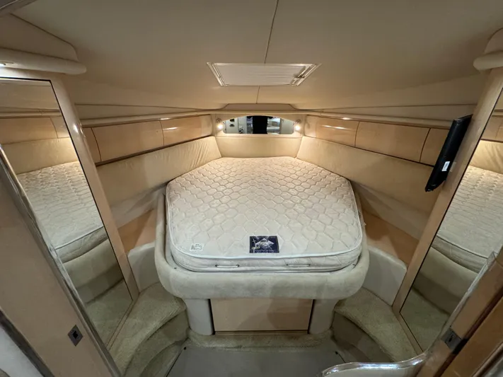  Yacht Photos Pics 2004 Sea Ray 360 Sundancer cabin interior with bed and mirrored walls.