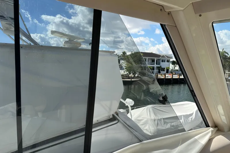 2009 Riviera 47 Yacht Photos Pics 2009 Riviera 47 Enclosed Flybridge Series II, view from interior, overlooking marina and waterfront homes.