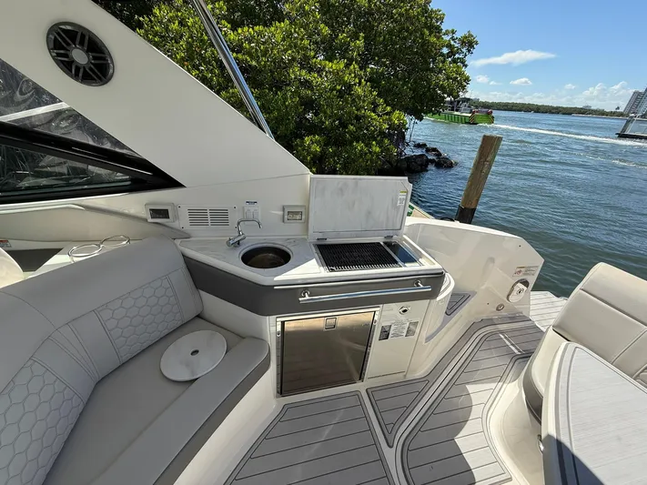  Yacht Photos Pics Luxurious 2022 Sea Ray Sundancer 320 Outboard boat with outdoor kitchen and scenic water view.