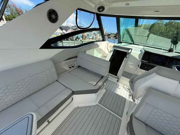  Yacht Photos Pics Luxurious interior of 2022 Sea Ray Sundancer 320 Outboard with modern seating and sleek design.