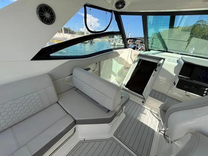  Yacht Photos Pics 2022 Sea Ray Sundancer 320 Outboard interior with modern seating and helm, dockside view.