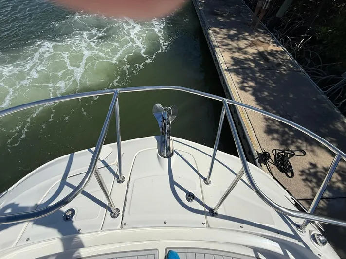  Yacht Photos Pics 2022 Sea Ray Sundancer 320 Outboard bow view near dock, with water and railing.