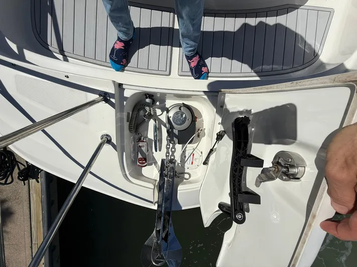  Yacht Photos Pics 2022 Sea Ray Sundancer 320 Outboard anchor compartment with person standing on deck.