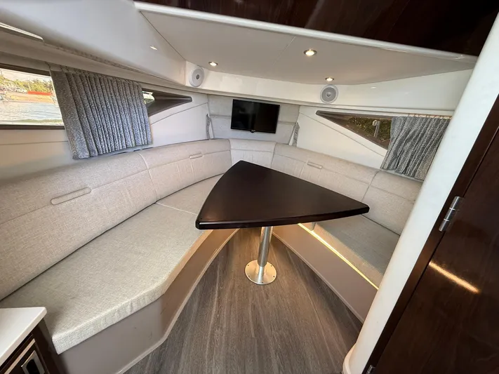  Yacht Photos Pics 2022 Sea Ray Sundancer 320 Outboard cabin with modern seating and triangular table.