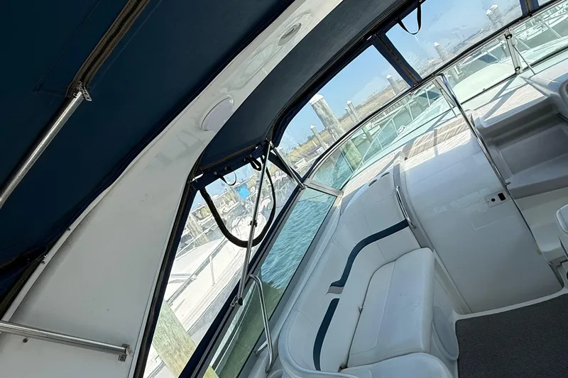  Yacht Photos Pics Interior view of a 1999 Formula 400 Super Sport boat with white seating and blue canopy.