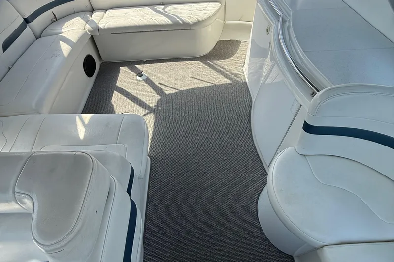  Yacht Photos Pics Interior of a 1999 Formula 400 Super Sport boat with white seating and carpet.