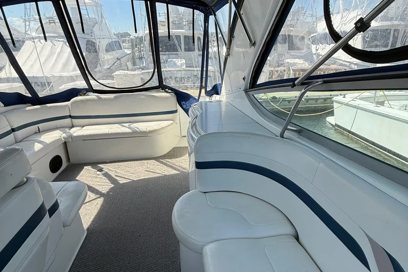  Yacht Photos Pics Interior of a 1999 Formula 400 Super Sport boat with white seating and windows.