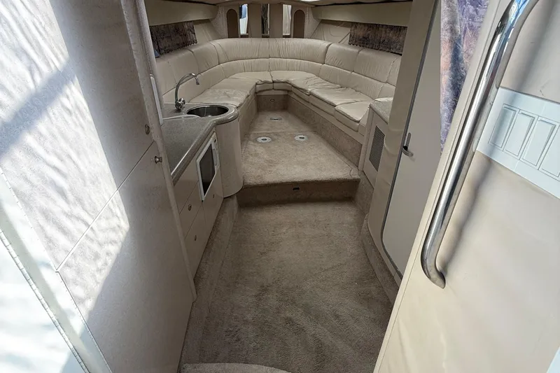  Yacht Photos Pics Interior of 1999 Formula 400 Super Sport boat with beige seating and kitchenette.