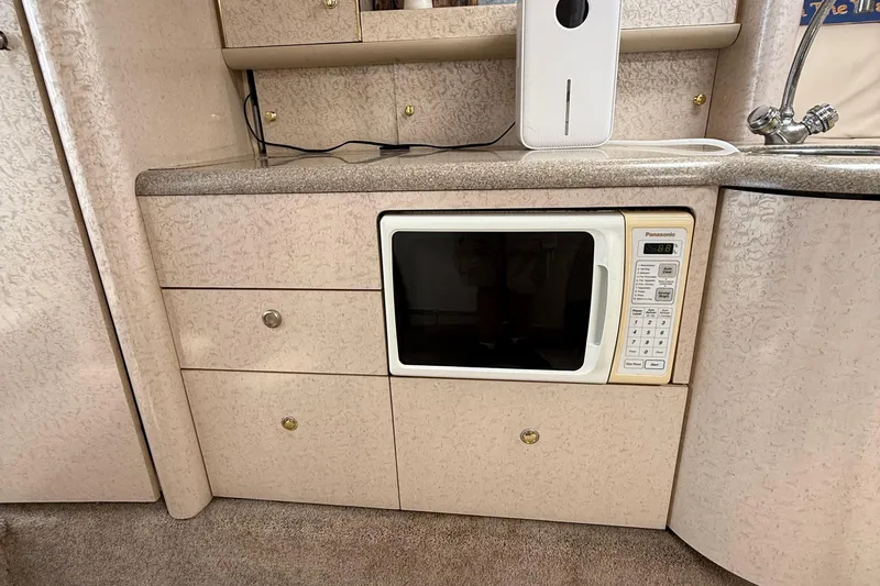  Yacht Photos Pics Interior of a 1999 Formula 400 Super Sport with built-in microwave and cabinetry.