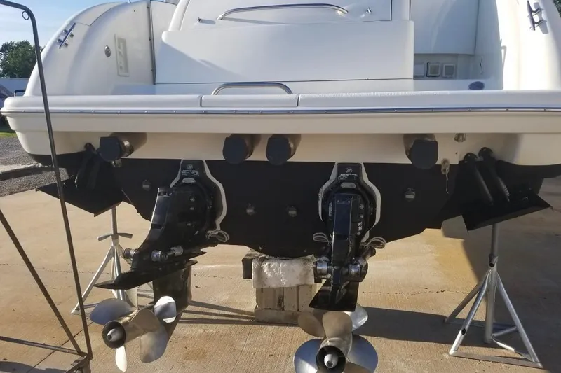  Yacht Photos Pics 1999 Formula 400 Super Sport boat stern with dual propellers on a concrete surface.