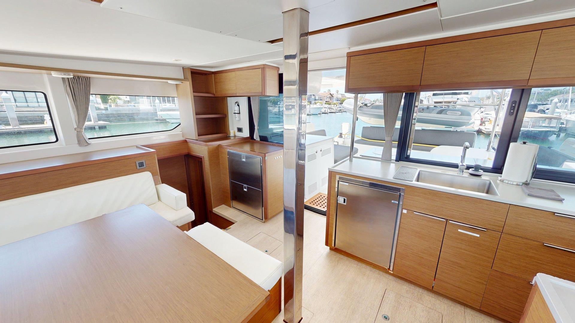 Interior of a 2020 Lagoon 46 catamaran with modern kitchen and dining area.