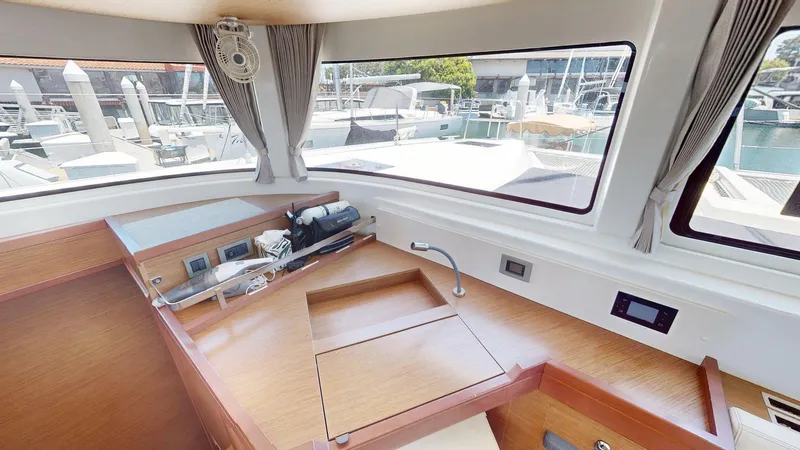 Sliver Fern Yacht Photos Pics Interior of 2020 Lagoon 46 yacht with wooden cabinetry and marina view.